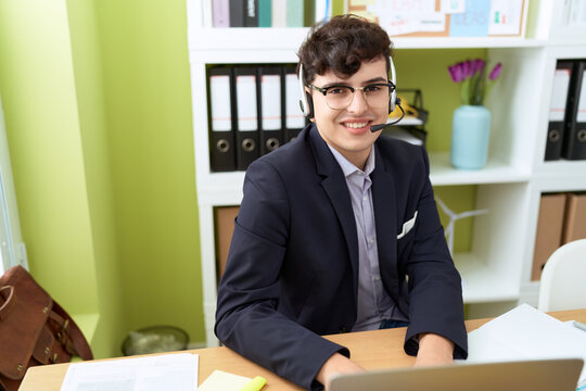Non binary man call center agent smiling confident working at office