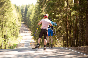 Roller skis.A man runs in a summer park on roller skis.Cross country skilling.