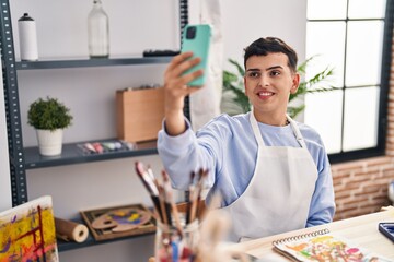 Young non binary man artist smiling confident make selfie by smartphone at art studio
