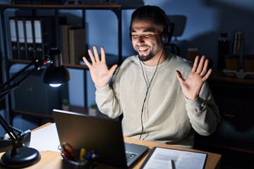 Fototapeta premium Young handsome man working using computer laptop at night celebrating mad and crazy for success with arms raised and closed eyes screaming excited. winner concept