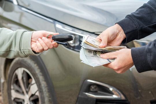Exchange money and car keys. Insurance, loan concept. Deal of buying or renting car