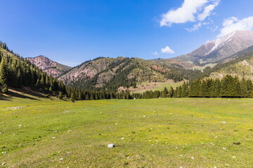 Mountain summer landscape of Jeti-Oguz (seven bulls) gorge near Issyk-Kul lake, Kyrgyzstan. Trekking to The Maiden's Tears Waterfall