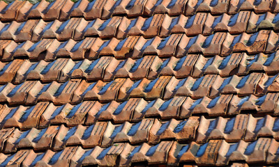 On the roof of the house is an old red tile