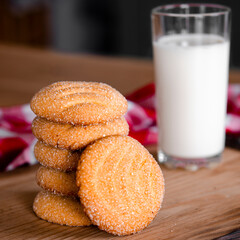 Homemade cakes. Homemade biscuits with a glass of milk on a wooden board