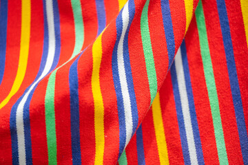 background of red striped madeiran fabric