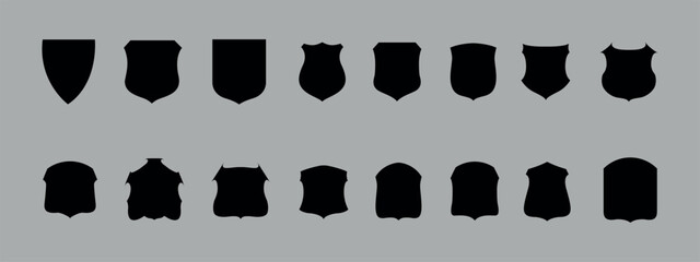 A set of black shields. Vector on gray background. 16 pieces.