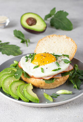 Homemade sandwich with ham, fried egg and avocado for breakfast, Vertical format