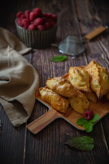 Little pastries with apples on dark wooden background 