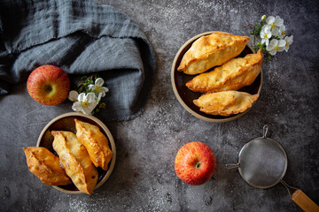 Pastries with apples and raspberries on dark background 