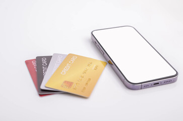 Credit card and mobile phone placed on white background