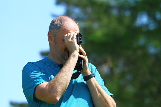 Man golfer with golf rangefinder