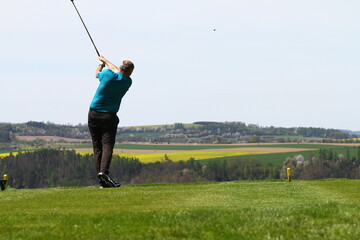 Man golfer on golf swing  with ball