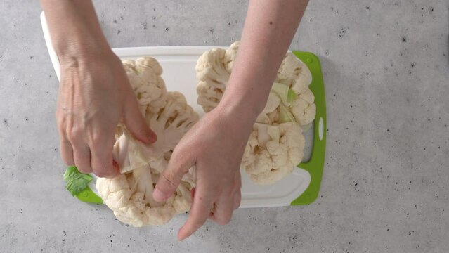 The chef devided cauliflower into florets, the cooking process, view from above. 