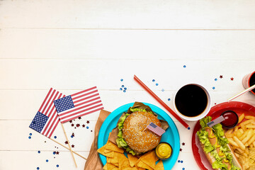 Composition with tasty dishes, drinks and paper American flags on light wooden background. Memorial...