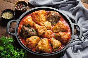 Cabbage Rolls with Ground Meat, Rice and Vegetables also known as Sarma, Golubtsy, Dolma on Rustic Wooden Background