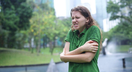 Sad woman under summer rain.emotional girl wet in the rain without umbrella.woman walk in the...