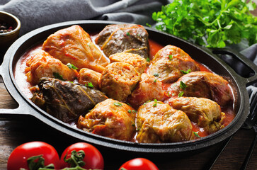 Cabbage Rolls with Ground Meat, Rice and Vegetables also known as Sarma, Golubtsy, Dolma on Rustic Wooden Background