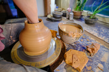 ceramics, workshop, ceramic art concept - close-up of man's hands forming a new vessel, man's...