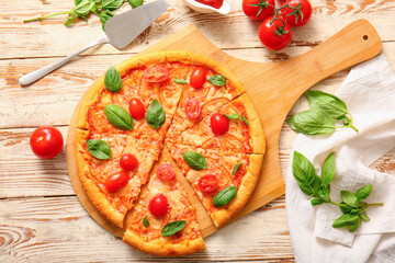 Board with tasty pizza margarita on white wooden background