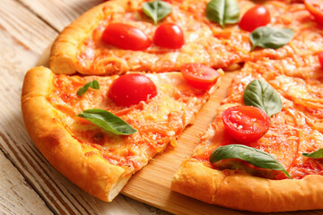 Board with tasty pizza margarita on white wooden background