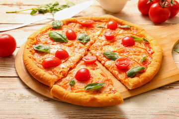 Board with tasty pizza margarita on white wooden background