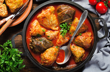 Cabbage Rolls with Ground Meat, Rice and Vegetables also known as Sarma, Golubtsy, Dolma on Rustic Wooden Background