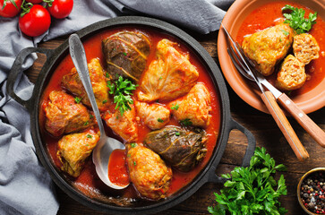 Cabbage Rolls with Ground Meat, Rice and Vegetables also known as Sarma, Golubtsy, Dolma on Rustic Wooden Background