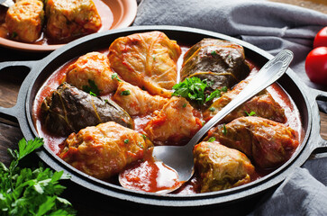 Cabbage Rolls with Ground Meat, Rice and Vegetables also known as Sarma, Golubtsy, Dolma on Rustic Wooden Background