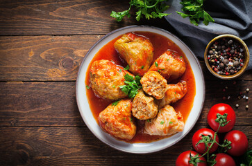Cabbage Rolls with Ground Meat, Rice and Vegetables also known as Sarma, Golubtsy, Dolma on Rustic Wooden Background