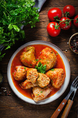 Cabbage Rolls with Ground Meat, Rice and Vegetables also known as Sarma, Golubtsy, Dolma on Rustic Wooden Background