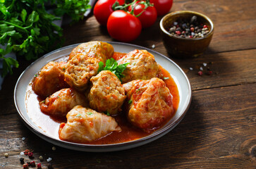 Cabbage Rolls with Ground Meat, Rice and Vegetables also known as Sarma, Golubtsy, Dolma on Rustic Wooden Background