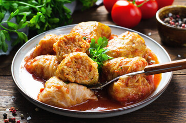 Cabbage Rolls with Ground Meat, Rice and Vegetables also known as Sarma, Golubtsy, Dolma on Rustic Wooden Background