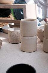 Beautiful handmade ceramics with neutral colours being displayed at a small market for handmade products. 