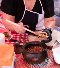 Woman making fresh whole wheat chicken empanadas at a food market in The Netherlands. Traditional Chilean savoury pastry.