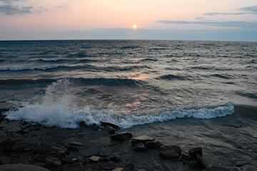 Lake Erie waves crashing while sun sets. New York.