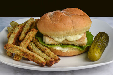 baked haddock sandwich  with broccoli fries and pickle