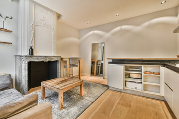 a living room with couches and a fire place in the middle of the room on the right is a fireplace