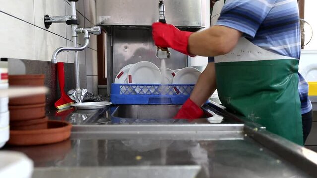A person washing dishes in a restaurant