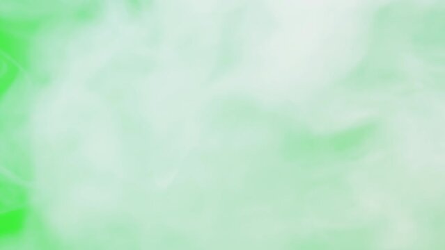 Abstract smoke on green chroma key background. Smoking cigarettes or marijuana weed, steam clouds close-up.