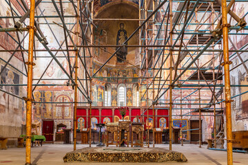 Gelati Monastery inside view of the Church of Virgin the Blessed, main nave, apse and iconostasis, with old frescos and murals in the apse, during renovation, Georgia.