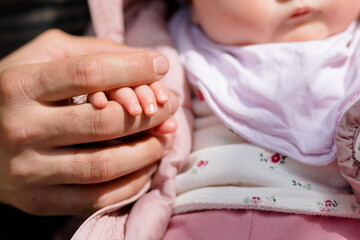 Fototapeta na wymiar The little palm of the newborn daughter on the hand of the father. Up close