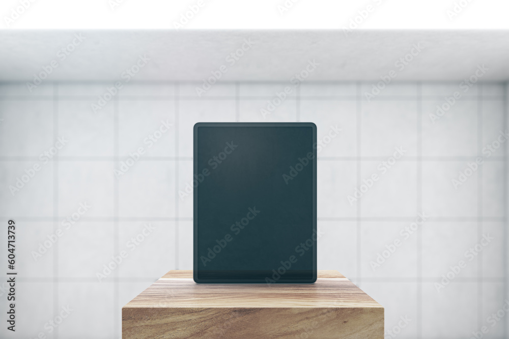 Poster Front view on blank black modern digital tablet screen with space for web design, website or application on wooden stage in empty room with light tiles wall background. 3D rendering, mockup