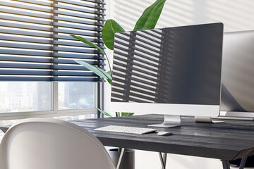 Side view of a modern office workplace with black desk with blank screen computer on big window with city view background in cozy interior, mockup. Office work and workspace concept. 3D Rendering