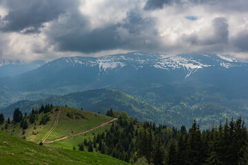 A trip through the spring mountains with a view of snow-capped peaks