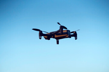 UAV technologies, modern drone is flying in the sky.