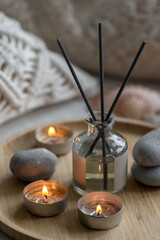 Aromatherapy, atmosphere of relax, serenity and pleasure. Concept of spa treatment in salon. Natural organic essential oil, towel, burning candles. Anti-stress, detox procedure, wellness