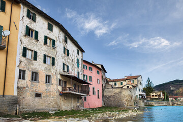 Santa Sofia, Forli Cesena, Emilia Romagna, Italy: view of the old town from the river shore with the ancient houses and the Apennine mountains on background