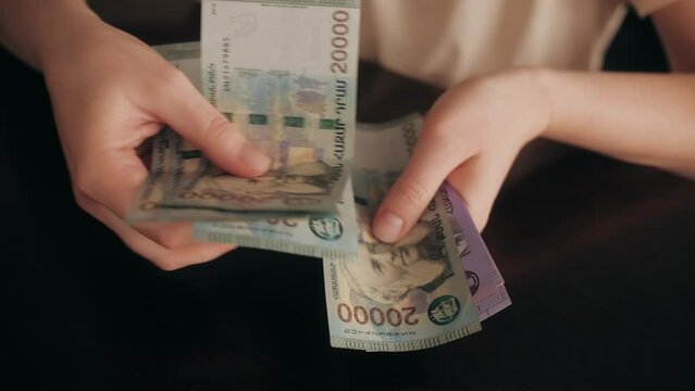 Man Counting Armenian Money Close up, Armenia dram amd banknotes, Tourist Exchgange Money in Bank of the Republic in Yerevan.