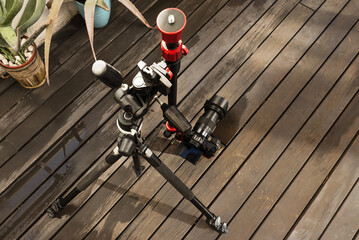 A camera mounted on a tripod with an articulating arm to be placed flush