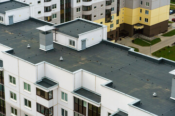 Dense urban development. A modern area of the city with beautiful multi-colored multi-storey buildings. Top view of the sleeping area of the city. © Pokoman
